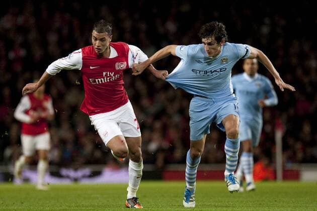 29.11.2011 London, England. Arsenal s Moroccan forward Marouane Chamakh and City s Montenegro defender Stefan Savic In action during the FA Carling Cup quarter final match between Arsenal and Manchester City played at The Emirates Stadium xMitchellxGunnx  ActionPlus11224193 Content restricted for UK based newspaper