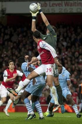 29.11.2011 London, England. City s Romanian goalkeeper Costel Pantilimon makes a save whilst under pressure from Arsenal s Moroccan forward Marouane Chamakh during the FA Carling Cup quarter final match between Arsenal and Manchester City played at The Emirates Stadium xMitchellxGunnx  ActionPlus11224197 Content restricted for UK based newspaper