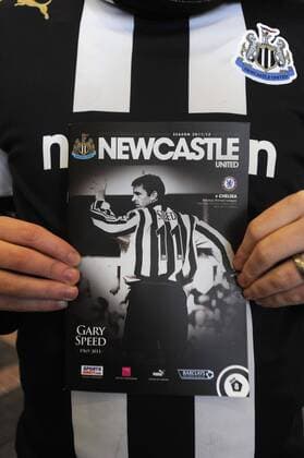 A fan holds up the commorative cover of the Newcastle United programme in memory of Gary Speed who passed away last week during the Premier League football match between Newcastle United and Chelsea FC on 3 December 2011, at St. James Park, Newcastle upon Tyne, England. Barclays Premier League Newcastle United v Chelsea 3rd December, 2011 EDITORIAL USE ONLY. No use with unauthorised audio, video, data, fixture lists, club league logos or live services. Online in-match use limited to 120 images, no video emulation. No use in betting, games or single club league player publications.
