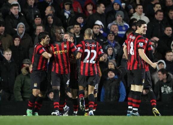 Manchester Citys Mario Balotelli celebrates scoring his sides opening goal EDITORIAL USE ONLY. No use with unauthorised audio, video, data, fixture lists, club league logos or live services. Online in-match use limited to 120 images, no video emulation. No use in betting, games or single club league player publications.