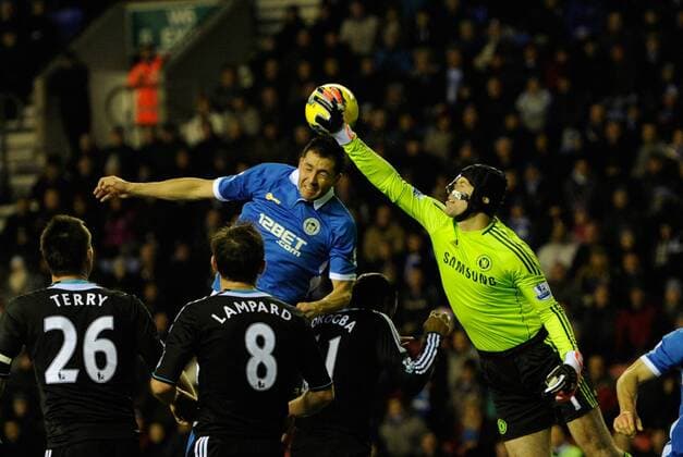 Petr Cech of Chelsea knocks the ball off the head of Antolin Alcaraz of Wigan Athletic EDITORIAL USE ONLY. No use with unauthorised audio, video, data, fixture lists, club league logos or live services. Online in-match use limited to 120 images, no video emulation. No use in betting, games or single club league player publications.