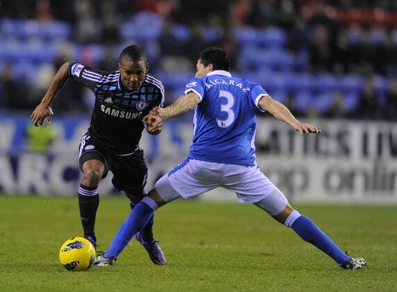 Florent Malouda of Chelsea goes past Antolin Alcaraz of Wigan Athletic Barclays Premier League Wigan Athletic v Chelsea 17th December, 2011 EDITORIAL USE ONLY. No use with unauthorised audio, video, data, fixture lists, club league logos or live services. Online in-match use limited to 120 images, no video emulation. No use in betting, games or single club league player publications.