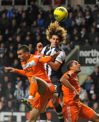 Fabricio Coloccini of Newcastle United (C) beats Steven Caulker (L) and Ashley Williams of Swansea City FC to the ball during the Premier League football match between Newcastle United and Swansea City on 17 December 2011, at Sports Direct Arena, Newcastle upon Tyne, England. EDITORIAL USE ONLY. No use with unauthorised audio, video, data, fixture lists, club league logos or live services. Online in-match use limited to 120 images, no video emulation. No use in betting, games or single club league player publications.