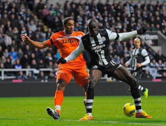 Demba Ba of Newcastle United (R) holds off Ashley Williams of Swansea City FC during the Premier League football match between Newcastle United and Swansea City on 17 December 2011, at Sports Direct Arena, Newcastle upon Tyne, England. EDITORIAL USE ONLY. No use with unauthorised audio, video, data, fixture lists, club league logos or live services. Online in-match use limited to 120 images, no video emulation. No use in betting, games or single club league player publications.