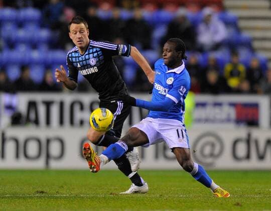 John Terry of Chelsea tackles Victor Moses of Wigan Athletic Barclays Premier League. Wigan Athletic vs Chelsea FC London. 17th December, 2011 EDITORIAL USE ONLY. No use with unauthorised audio, video, data, fixture lists, club league logos or live services. Online in-match use limited to 120 images, no video emulation. No use in betting, games or single club league player publications.