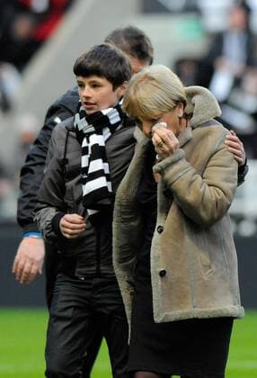 Gary Speed s son (L) comforts his grandmother Carol Speed after the tribute to former player Gary Speed during the Premier League football match between Newcastle United and Swansea City on 17 December 2011, at Sports Direct Arena, Newcastle upon Tyne, England. EDITORIAL USE ONLY. No use with unauthorised audio, video, data, fixture lists, club league logos or live services. Online in-match use limited to 120 images, no video emulation. No use in betting, games or single club league player publications.