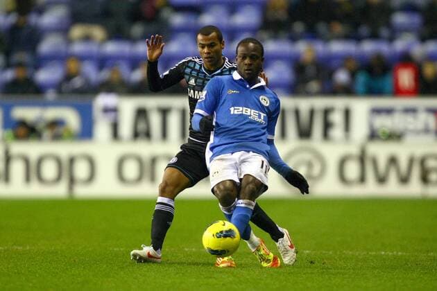Football - Premier League - Wigan Athletic vs. Chelsea Ashley Cole of Chelsea and Wigan s Victor Moses at the DW Stadium 