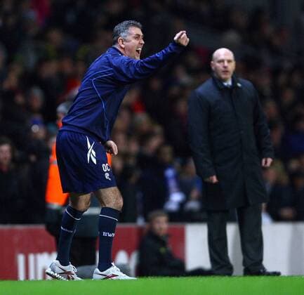 Football - Premier League - Blackburn Rovers vs. Bolton Wanderers Manager of Bolton, Owen Coyle urges on his players as Steve Kean manager of Blackburn Rovers watches on at Ewood Park 