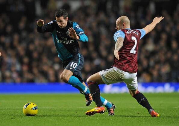 Football - Premier League - Aston Villa vs. Arsenal FC London Aston Villa s Alan Hutton attempts to tackle Arsenal s Robin van Persie at Villa Park, Birmingham 