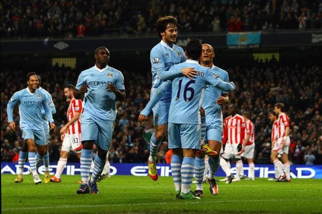 Football - Premier League - Manchester City vs. Stoke City Sergio Kun Aguero of Manchester City celebrates his opening goal with David Silva at the Etihad Stadium 