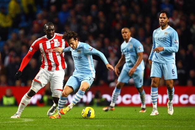 Football - Premier League - Manchester City vs. Stoke City Stoke s Kenwyne Jones hassles David Silva of Manchester City at the Etihad Stadium 