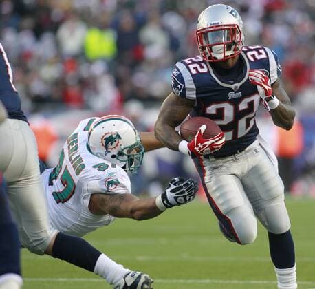 New England Patriots running back Stevan Ridley (22) dodges a tackle by Miami Dolphins defensive end Phillip Merling (97) on a five yard carry in the third quarter at Gillette Stadium in Foxboro, Massachusetts on December 24, 2011. The Patriots defeated the Dolphins 27-24.  BOS2011122417