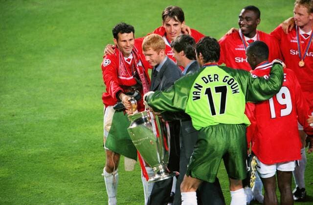 Ryan Giggs and United team mates pass over the trophy to Paul Scholes and Roy Keane who missed playing in the final. Manchester United v Bayern Munich, Champions League Cup Final; 26 05 1999; Barcelona. 