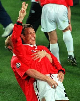 David May (Manchester) gets to grip with goal scorer Teddy Sheringham as United celebrate the treble. Manchester United 2:1 Bayern Munich, Champions League Cup Final, 26 05 1999. Barcelona. 