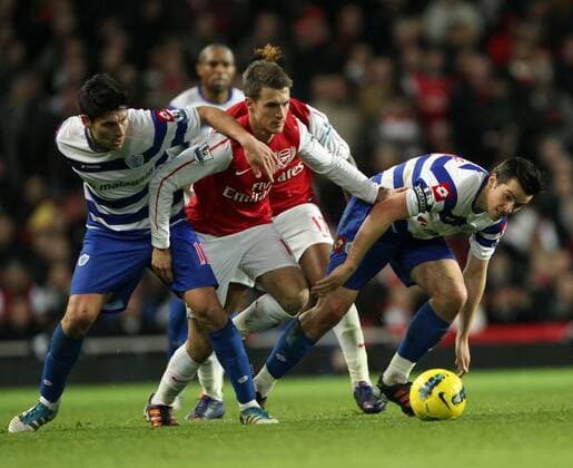FC Arsenals Aaron Ramsay tussles with QPRs Alejandro Faurlin and Joey Barton Barclays Premier League FC Arsenal v Queens Park Rangers at the Emirates, London 31st December, 2011 EDITORIAL USE ONLY. No use with unauthorised audio, video, data, fixture lists, club league logos or live services. Online in-match use limited to 120 images, no video emulation. No use in betting, games or single club league player publications.