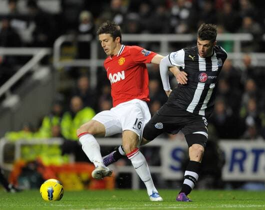 Michael Carrick of Manchester United (L) and Davide Santon of Newcastle United. Barclays Premier League Newcastle United v Manchester United at The Sports Direct Arena, Newcastle upon Tyne 4th January, 2012 EDITORIAL USE ONLY. No use with unauthorised audio, video, data, fixture lists, club league logos or live services. Online in-match use limited to 120 images, no video emulation. No use in betting, games or single club league player publications.