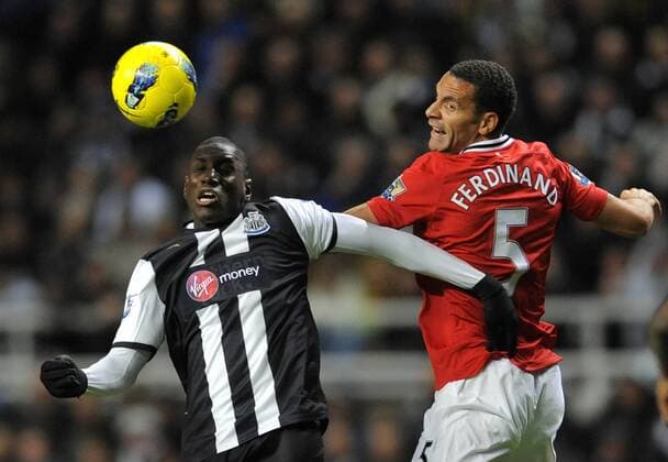 Demba Ba of Newcastle United (L) beats Rio Ferdinand of Manchester United to the ball. Barclays Premier League Newcastle United v Manchester United at The Sports Direct Arena, Newcastle upon Tyne 4th January, 2012 EDITORIAL USE ONLY. No use with unauthorised audio, video, data, fixture lists, club league logos or live services. Online in-match use limited to 120 images, no video emulation. No use in betting, games or single club league player publications.