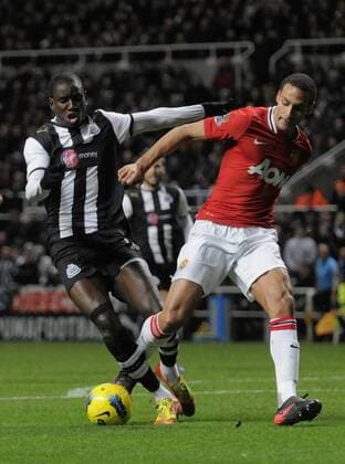 Demba Ba of Newcastle United (L) and Rio Ferdinand of Manchester United to the ball. Barclays Premier League Newcastle United v Manchester United at The Sports Direct Arena, Newcastle upon Tyne 4th January, 2012 EDITORIAL USE ONLY. No use with unauthorised audio, video, data, fixture lists, club league logos or live services. Online in-match use limited to 120 images, no video emulation. No use in betting, games or single club league player publications.