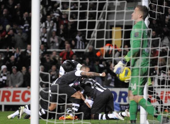 Newcastle United players mob Demba Ba after scoring his side s first goal. Barclays Premier League Newcastle United v Manchester United at The Sports Direct Arena, Newcastle upon Tyne 4th January, 2012 EDITORIAL USE ONLY. No use with unauthorised audio, video, data, fixture lists, club league logos or live services. Online in-match use limited to 120 images, no video emulation. No use in betting, games or single club league player publications.