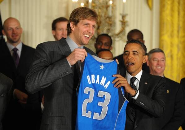 U.S. President Barack Obama receives a Dallas Mavericks jersey from Mavericks Dirk Nowitzki, of Germany, during a ceremony honoring the 2011 NBA Basketball Herren USA Champions in the East Room of the White House on January 9, 2012 in Washington, DC. Obama shared some laughs as he congratulated Dallas for their first National Basketball League Championship.  WAP20120109106