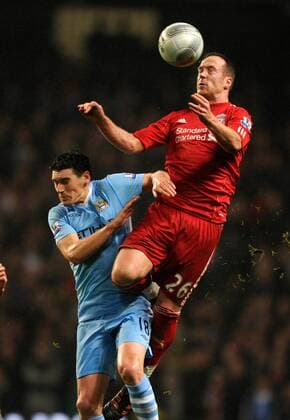 Charlie Adam of Liverpool rises above Gareth Barry of Manchester City The Carling Cup, Semi Final 1st leg Manchester City v Liverpool at the Etihad Stadium, Manchester. 11th January, 2012 EDITORIAL USE ONLY. No use with unauthorised audio, video, data, fixture lists, club league logos or live services. Online in-match use limited to 120 images, no video emulation. No use in betting, games or single club league player publications.