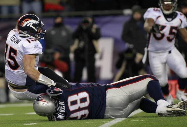 New England Patriots defensive lineman Gerard Warren (98) sacks Denver Broncos quarterback Tim Tebow (15) in the second quarter of the AFC divisional playoff game at Gillette Stadium in Foxboro, Massachusetts on January 14, 2012.  BOS2012011412
