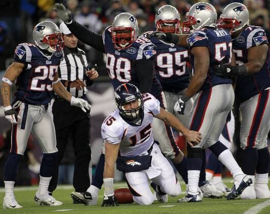 New England Patriots defensive lineman Gerard Warren (98) celebrates after he sacked Denver Broncos quarterback Tim Tebow (15) in the second quarter of the AFC divisional playoff game at Gillette Stadium in Foxboro, Massachusetts on January 14, 2012.  BOS2012011413