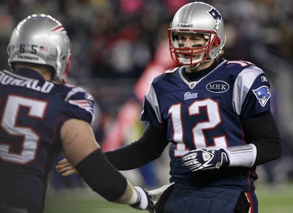 New England Patriots quarterback Tom Brady (12) gives a high five to offensive lineman Nick McDonald (65) after the Patriots scored against the Denver Broncos in the second quarter of the AFC divisional playoff game at Gillette Stadium in Foxboro, Massachusetts on January 14, 2012.  BOS2012011414