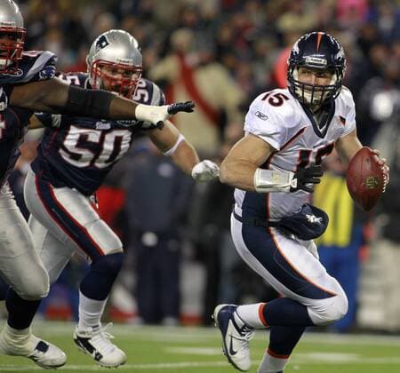 Denver Broncos quarterback Tim Tebow scrambles from the pocket while under pressure from the New England Patriots defense in the first quarter of the AFC divisional playoff game at Gillette Stadium in Foxboro, Massachusetts on January 14, 2012.  BOS2012011416