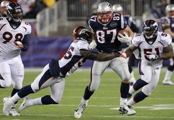 New England Patriots tight end Ron Gronkowski (87) attempts to shed a tackle by Denver Broncos linebacker D.J. Williams (55) on a twenty-yard reception in the third quarter of the AFC divisional playoff game at Gillette Stadium in Foxboro, Massachusetts on January 14, 2012. The Patriots defeated the Broncos 45-10.  BOS2012011421