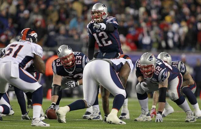 New England Patriots quarterback Tom Brady (12) calls a play from the line in the third quarter against the Denver Broncos at Gillette Stadium in Foxboro, Massachusetts on January 14, 2012. The Patriots defeated the Broncos 45-10.  BOS2012011427
