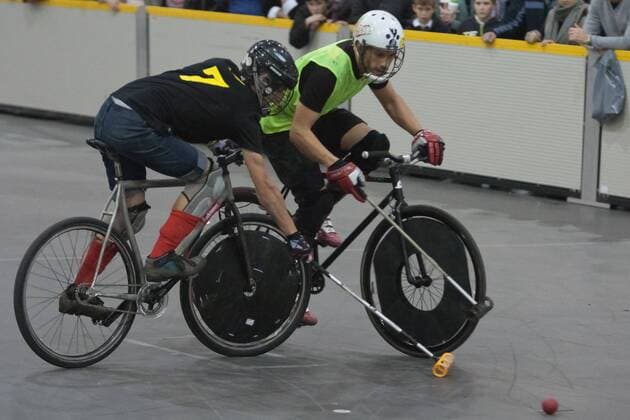 15.01.12 London, England. Players tussle for the ball during the London International Invitational bike polo quarter finals match at The Bike Show between Dead Rappers (black shirts) from London and El Club (yellow bibs) from Barcelona, Spain at ExCeL Centre, East London. xDavidxFearn ActionxPlusx  ActionPlus11235023