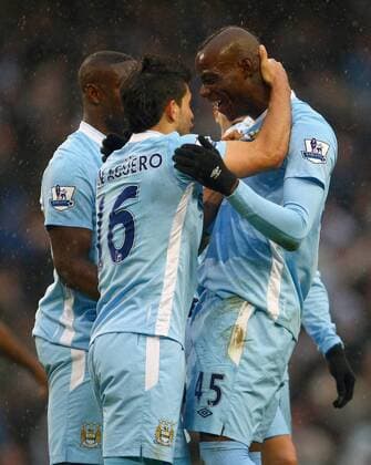 Football - Premier League - Manchester City vs. Tottenham Hotspur Sergio Kun Agüero of Manchester City congratulates Mario Balotelli on his penalty kick at the Etihad Stadium 