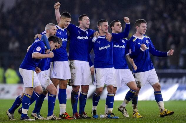 24.1.2012 Cardiff, Wales. Cardiff players celebrate after Defender Anthony Gerrard (IRL) scores during the penalty shootout in the Carling Cup Semi-Final second leg football match between Cardiff City and Crystal Palace at Cardiff City Stadium. xRoganxThomsonx  ActionPlus11238342