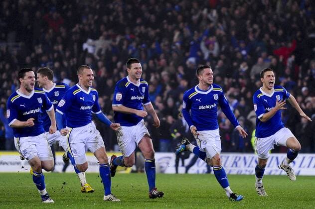 24.1.2012 Cardiff, Wales. Cardiff players celebrate after their team win the game in a penalty shootout during the Carling Cup Semi-Final second leg football match between Cardiff City and Crystal Palace at Cardiff City Stadium. xRoganxThomsonx  ActionPlus11238344