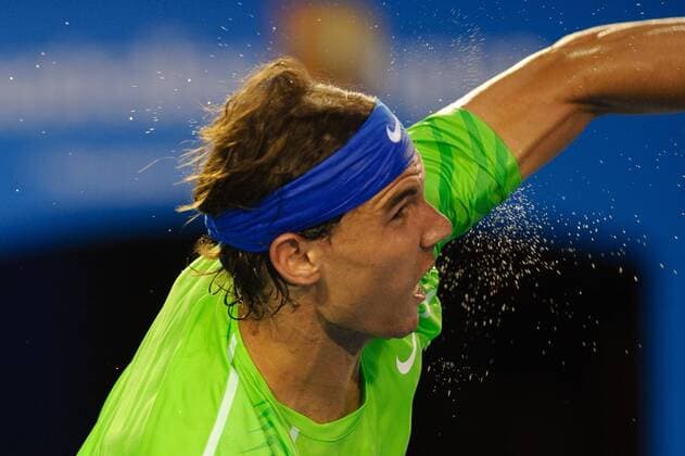 Jan. 29, 2012 - Melbourne, Victoria, Australia - Beads of perspiration fly off Rafael Nadal (ESP) as he serves during the men s finals match on day 14 of the 2012 Australian Open at Melbourne Park, Australia. TENNIS 2012 - Australian Open 2012 - Day 12 - ZUMAx35