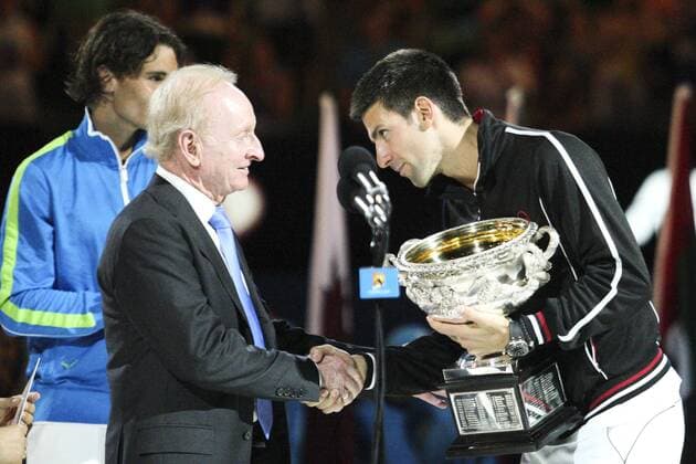 29 January 2012 : Novak Djokovic (SRB) in his final match against Rafael Nadal (ESP) graciously accepts the winners trophy of Australian tennis legend Rod Laver after winning an epic 5 set final during Day 14 of the Mens final of the Australian Tennis open grand slam event at Melbourne Park, Melbourne Australia. TENNIS: JAN 29 Australian Open - Men s Final Icon12012932 EDITORIAL USE ONLY