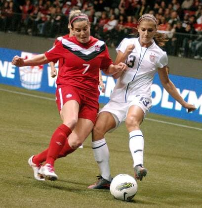 Alex Morgan (R) of US and Rhian Wilkinson of Canada fight for the ball during their final at 2012 CONCACAF Women s Olympic Qualifying Soccer Tournament at BC Place in Vancouver, Canada, Jan. 29, 2012. US defeated Canada 4-0 and captured the CONCACAF trophy. Both teams qualified to go to 2012 Summer Olympic Games in London. (Xinhua Sergei Bachlakov) CANADA-VANCOUVER-CONCACAF-WOMEN S OLYMPIC QUALIFYING-FINAL 