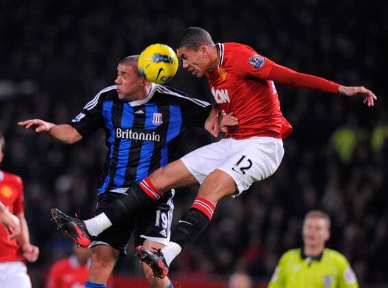 Jonathan Walters of Stoke City challenges Chris Smaling of Manchester United.Barclays Premier League match between.Manchester United v Stoke City at the Old Trafford Stadium, Manchester on the 31st January 2012. EDITORIAL USE ONLY. No use with unauthorised audio, video, data, fixture lists, club league logos or live services. Online in-match use limited to 120 images, no video emulation. No use in betting, games or single club league player publications.