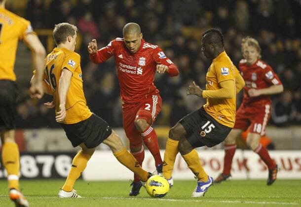 Glen Johnson of FC Liverpool falls under a challenge from Emmanuel Frimpong and Christophe Berra of Wolverhampton Wanderers but fails to earn a penalty kick...Barclays Premier League.Wolverhampton Wanderers v FC Liverpool, Molineux Wolverhampton, January 31st 2012. EDITORIAL USE ONLY. No use with unauthorised audio, video, data, fixture lists, club league logos or live services. Online in-match use limited to 120 images, no video emulation. No use in betting, games or single club league player publications.