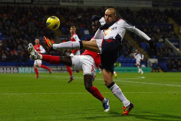 Football - Premier League - Bolton Wanderers vs. FC Arsenal FC Arsenal s Bacary Sagna and Martin Petrov of Bolton in action at the Reebok Stadium 