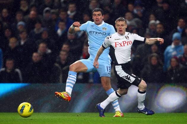 Football - Premier League - Manchester City vs. Fulham FC Aleksander Kolarov of Manchester City and Fulham s Damien Duff in action at the Etihad Stadium 