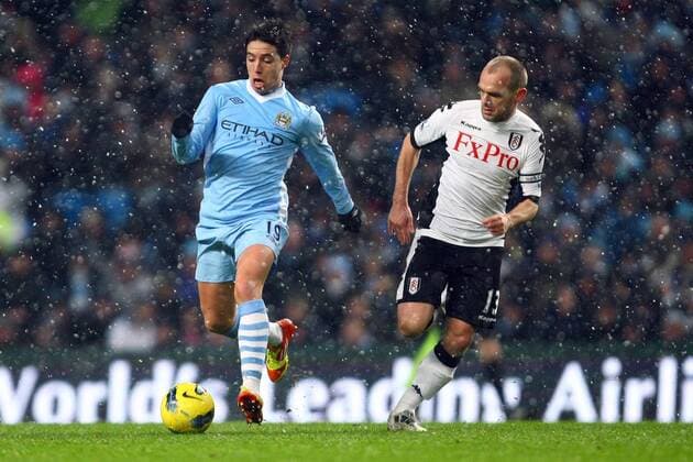 Football - Premier League - Manchester City vs. Fulham FC Fulham s Danny Murphy chases down Samir Nasri of Manchester City at the Etihad Stadium 