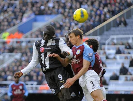 Papiss Demba Cisse of Newcastle United (L) beats Stephen Warnock of Aston Villa to the cross.Barclays Premier League match between Newcastle United v Aston Villa at the Sports Direct Arena at Newcastle upon Tyne on 5th February 2012. EDITORIAL USE ONLY. No use with unauthorised audio, video, data, fixture lists, club league logos or live services. Online in-match use limited to 120 images, no video emulation. No use in betting, games or single club league player publications.