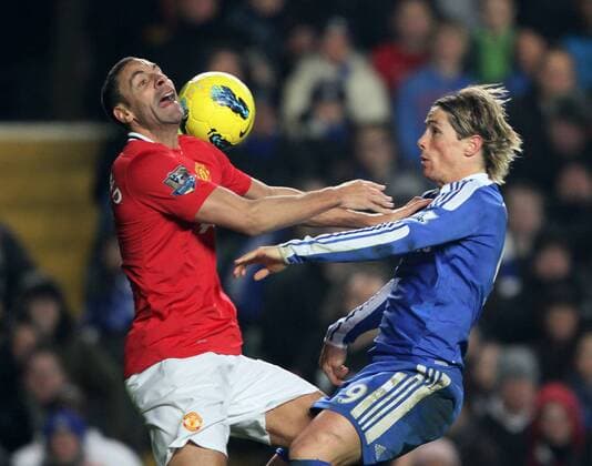 Chelseas Fernando Torres tussles with Manchester Uniteds Rio Ferdinand.- Chelsea FC London vs. Manchester United in the the Barclays Premier League at the Stamford Bridge, London. 5th February 2012. EDITORIAL USE ONLY. No use with unauthorised audio, video, data, fixture lists, club league logos or live services. Online in-match use limited to 120 images, no video emulation. No use in betting, games or single club league player publications.
