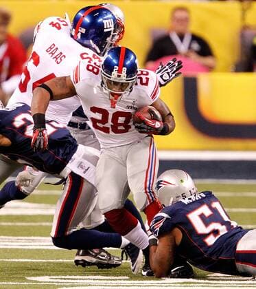 Feb. 5, 2012 - Indianapolis, IN, USA - Running back D.J. Ware (28) of the New York Giants was caught by middle linebacker Jerod Mayo (51) of the New England Patriots in first-quarter action of Superbowl XLVI on Sunday, February 5, 2012, at Lucas Oil Stadium in Indianapolis, Indiana. Super Bowl XLVI - ZUMAm67