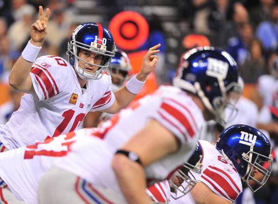 New York Giants quarterback Eli Manning signals during his first series of downs against the New England Patriots in the first quarter at Super Bowl XLVI at Lucas Oil Stadium on February 5, 2012 in Indianapolis. The NFC champion New York Giants play the AFC champion New England Patriots.  SBP20120205321