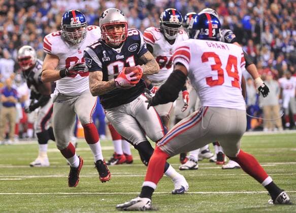 New England Patriots tight end Aaron Hernandez (81) runs for a touchdown on a 12-yard pass against the New York Giants during the third quarter at Super Bowl XLVI at Lucas Oil Stadium on February 5, 2012 in Indianapolis.  SBP20120205338
