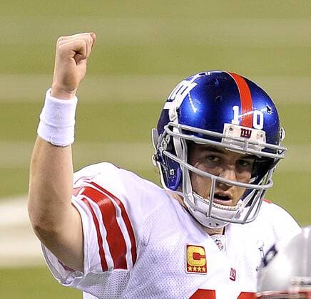 New York Giants quarterback Eli Manning pumps his fist after throwing a touchdown pass against the New England Patriots during Super Bowl XLVI February 5, 2012, in Indianapolis. (UPI Photo Brian Kersey)  SBP20120205999