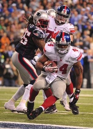 New York Giants running back Ahmad Bradshaw scores the game-winning touchdown on a 6-yard run in the fourth quarter against the New England Patriots at Super Bowl XLVI at Lucas Oil Stadium on February 5, 2012 in Indianapolis. The Giants beat the Patriots 21-17 to win Super Bowl XLVI..  SBP20120205370